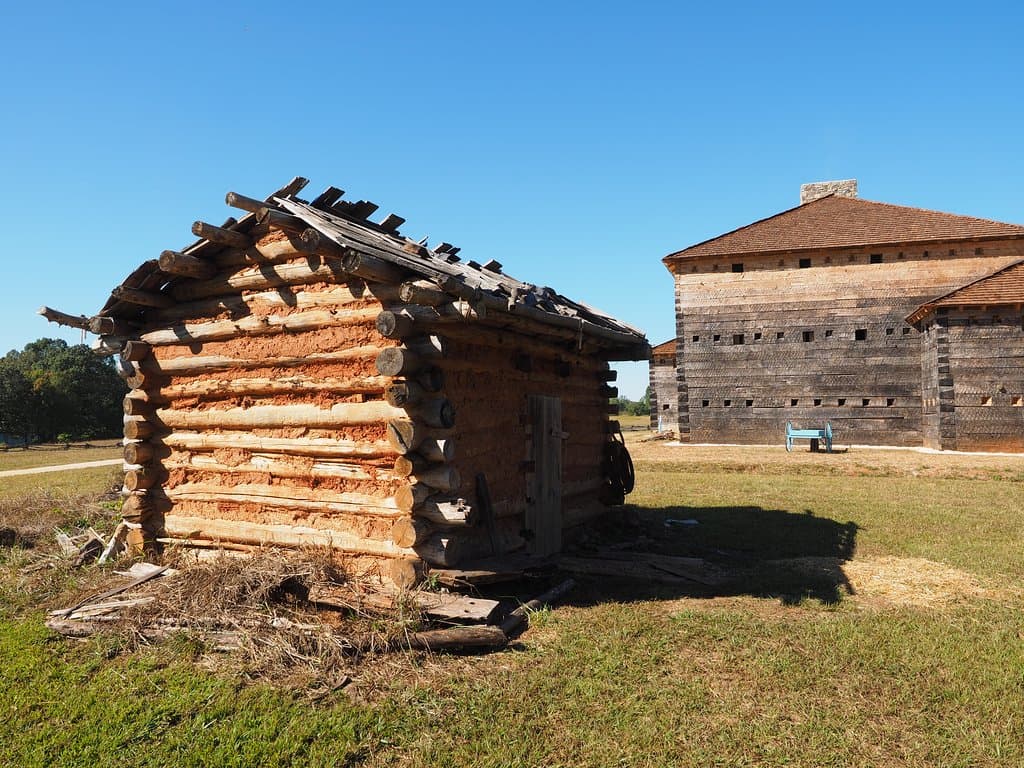 Settlers cabin and Fort Dobbs in the background
