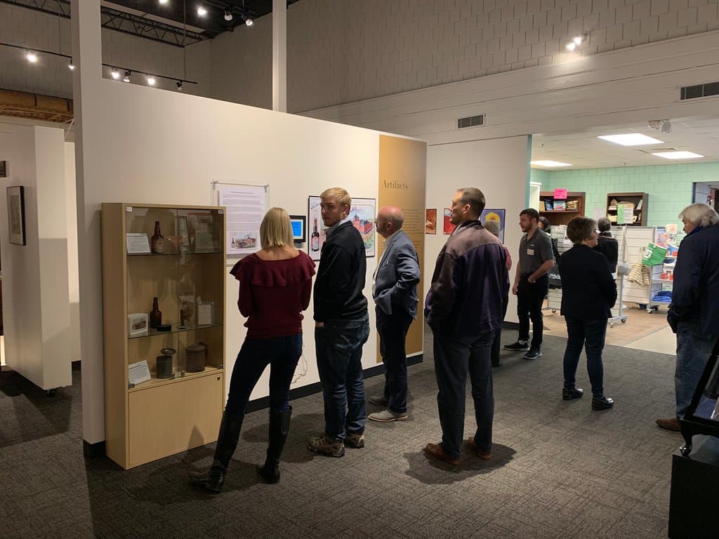 Visitors learning about the story of our area through artifacts.