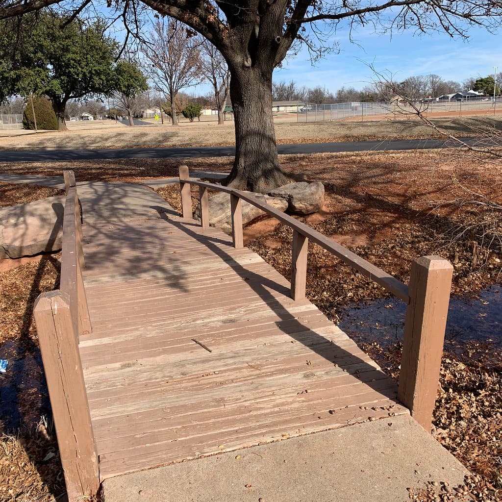 Wooden bridge across lake.