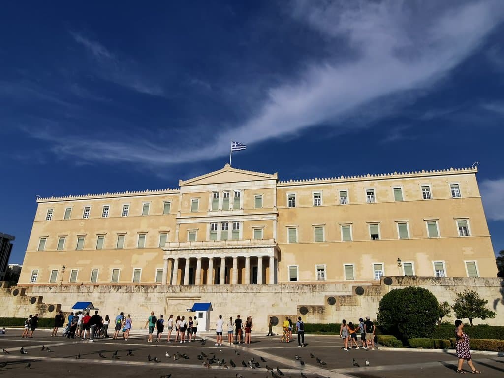 Tourists in front of the Parliament building. It is the main object of protests.