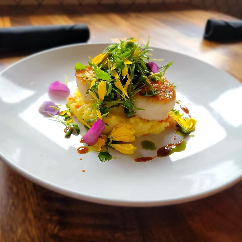 We offer multiple Specials in addition to our Menus.  Pictured here: Pan Seared Scallops over a Saffron Risotto, with Fresh Herbs & a Copper Honey Gastrique