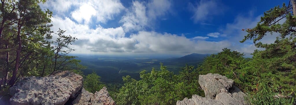 Use the panorama feature on your phone or camera to get a spectacular shot.   This one was taken a few hundred feet from the viewing platform where the two rocks serve as natural bookends.  