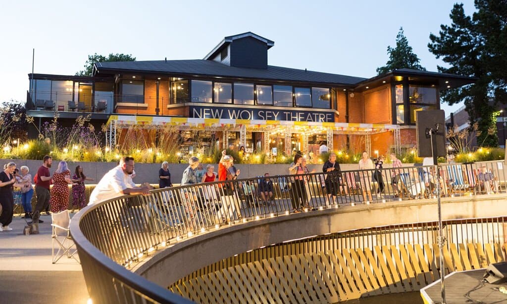 People gathered around the theatre bowl at Theatre Square for a performance.