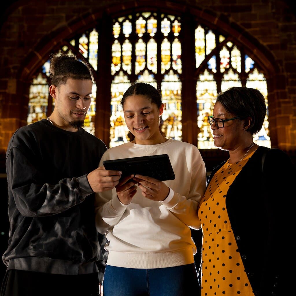 Visitors enjoying the new augmented reality digital tour in the Great Hall at St Mary's Guildhall Coventry.