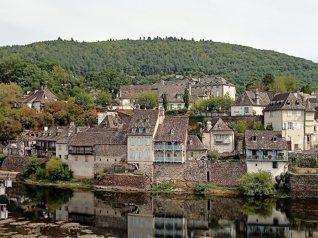 View on East bank Dordogne river from Pont de la Republique, Argentat. September 2022.