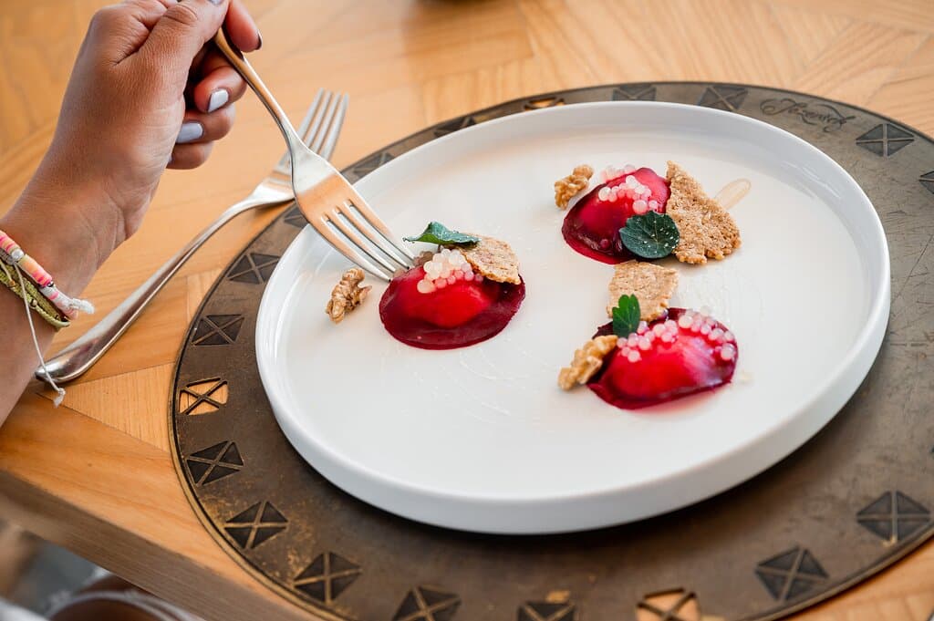 Beetroot pockets stuffed with smoked sea bass
and cottage cheese, marinated pear, honey,
and walnuts