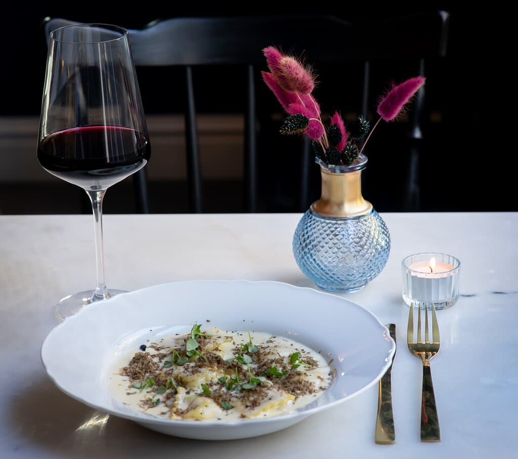 The ravioli, filled with mushrooms & truffle. Served in a truffle cream sauce and topped with fresh shaved truffle and basil cress.