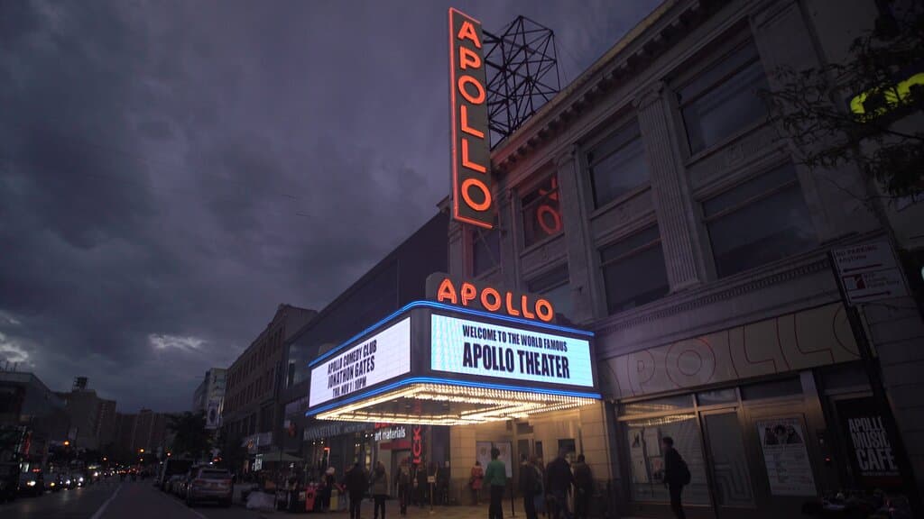 exterior photo of the Apollo marquee reading "welcome to the world famous Apollo Theater"