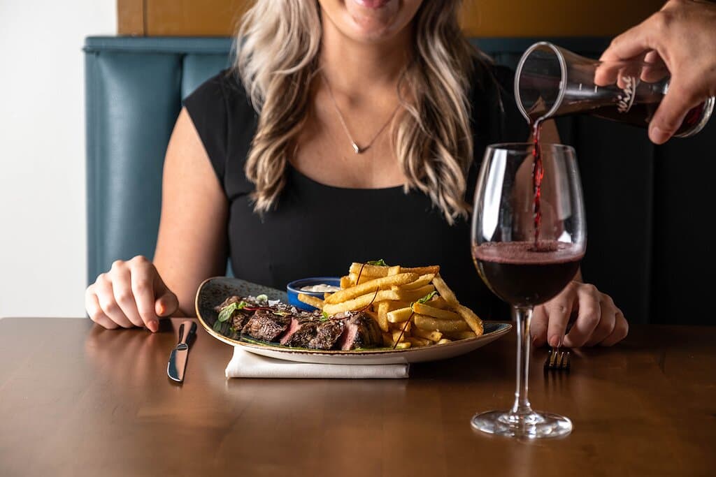 Steak Frites 12 oz NY Strip, chimichurri, goat cheese truffle fries, garlic aioli