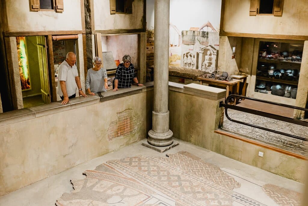 Visitors looking at the Roman mosaics.