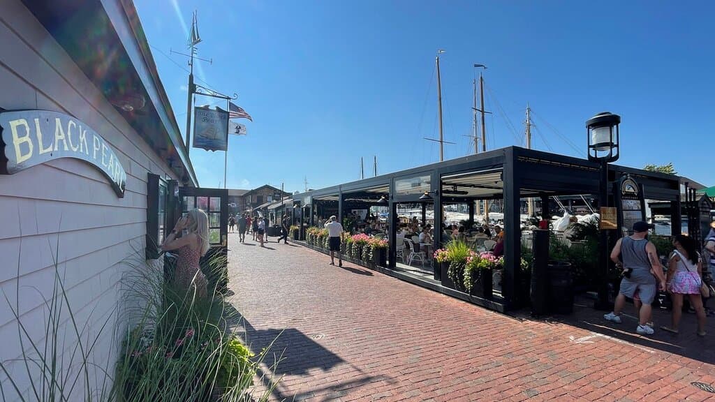Beautiful day looking down Bannisters Wharf, with the main building on the left and the covered patio on the right.