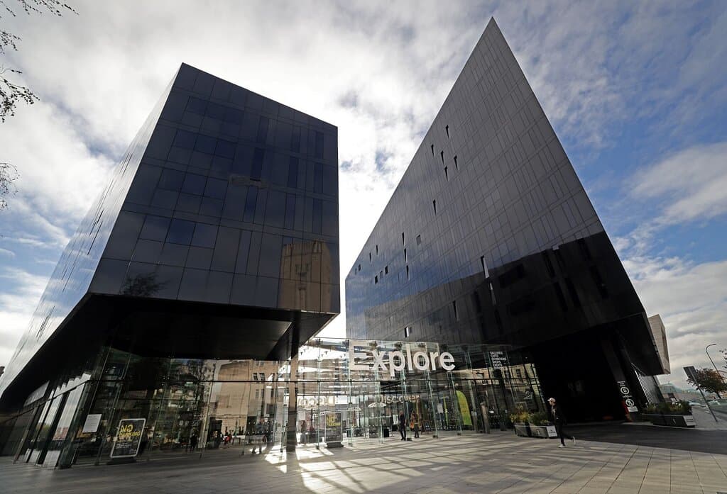 Tate Liverpool is temporarily based at RIBA North on Mann Island. This is a photograph of the exterior of the Mann Island complex in Liverpool. It includes two large black buildings.