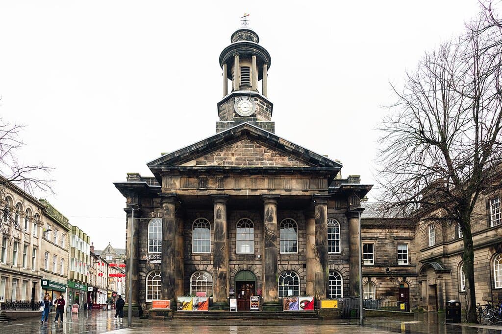 The historic Lancaster City Museum, with clocktower, seen from the outside on an overcast day