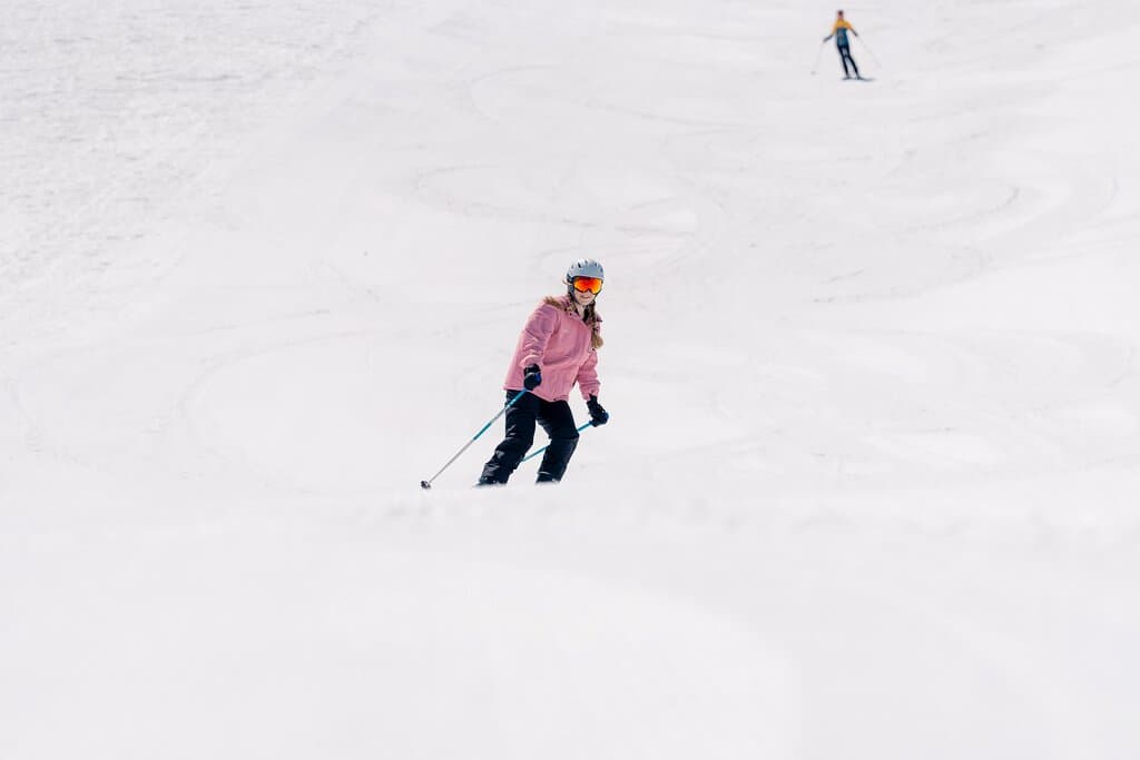A person skiing down a snowy hill.