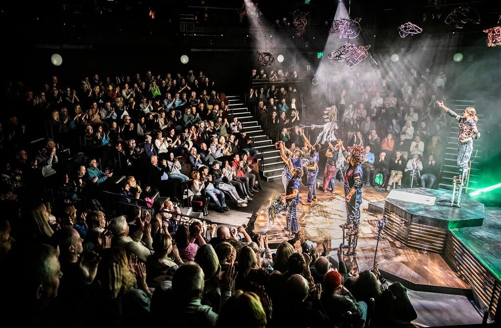 Full auditorium applauding Animal Farm cast