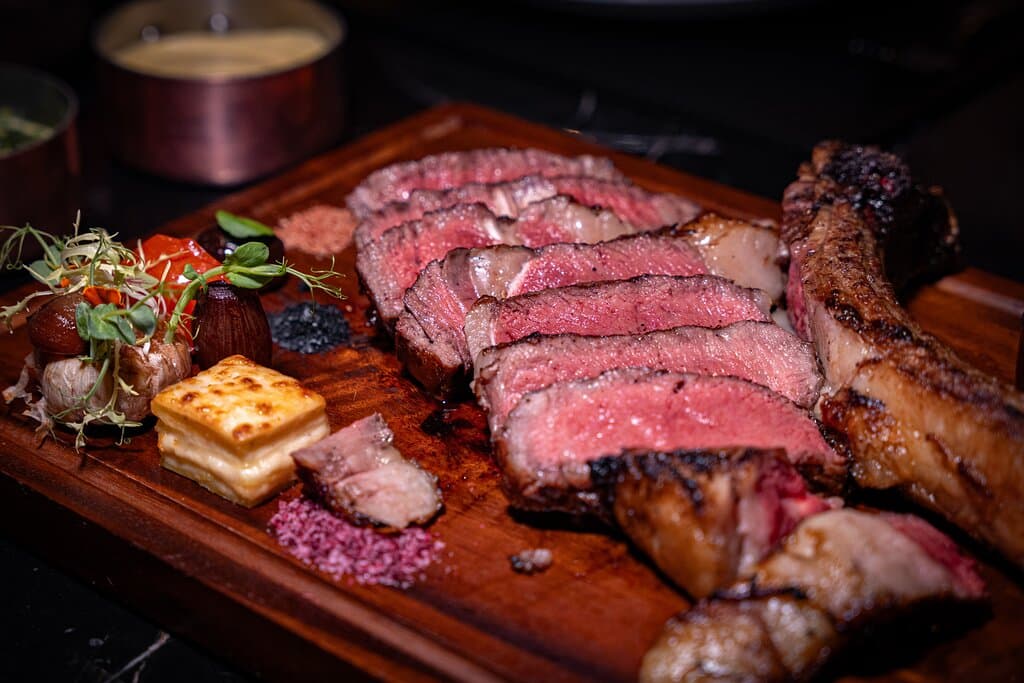A 1.2kg Tomahawk steak, perfectly cooked and ready to be savored at The District Grill Room and Bar.