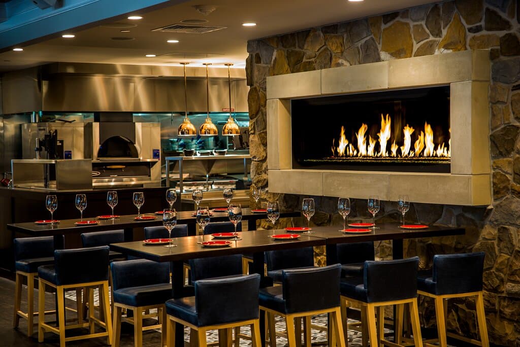 Experience the energetic and engaging atmosphere of Fire & Grain® restaurant, featuring gathering tables, a fire wall, and a full service bar.