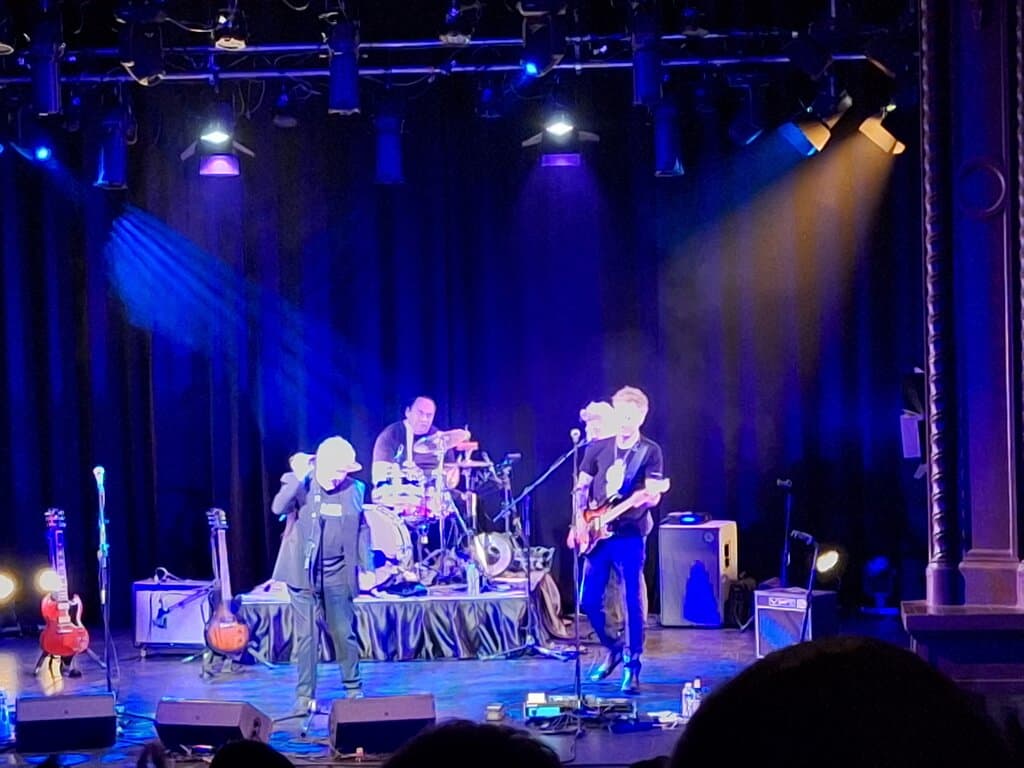 Ross Wilson and band on stage.