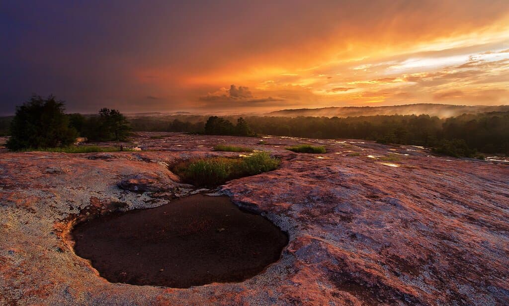 A summer sunrise at the peak of Arabia Mountain. The 2,200-acre Davidson-Arabia Mountain Nature Preserve is one of our primary partners and at the heart of the National Heritage Area.