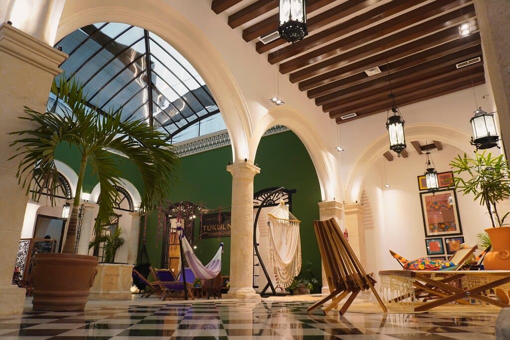 En el corazón de la Ciudad de Campeche, a unos pasos de la icónica Calle 59, se encuentra la Casa de Artesanías Tukulná, un espacio único donde tradición, cultura y diseño se encuentran. Fundada en 1997 y ubicada en una majestuosa casona del siglo XVIII, Tukulná ofrece piezas artesanales auténticas: desde guayaberas y hamacas hasta joyería en cuerno de toro, sombreros de jipijapa y textiles bordados a mano.