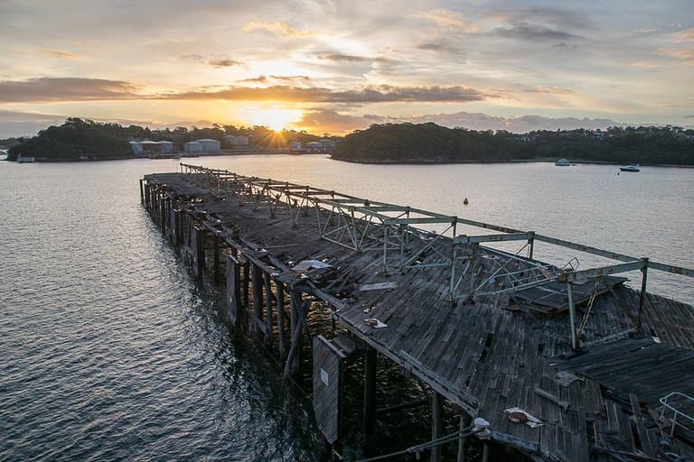 Dilapidated wharf looking towards oil storage facility at Greenwich.
