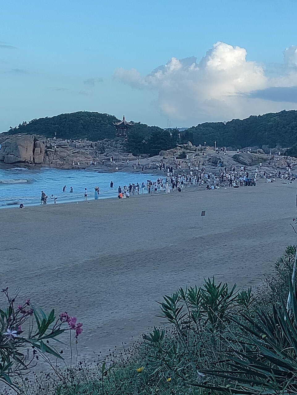 The northern end of the beach: view to the south, showing a small temple picturesquely perched on the cliff.