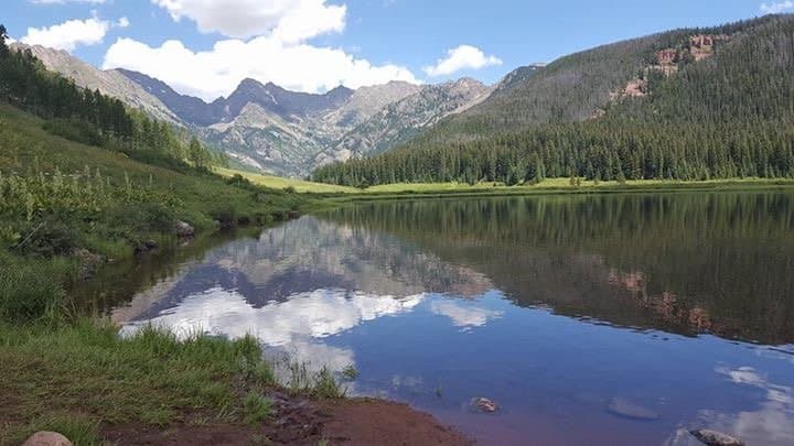 Beautiful refection of Upper Piney Lake with mountain backdrop.
