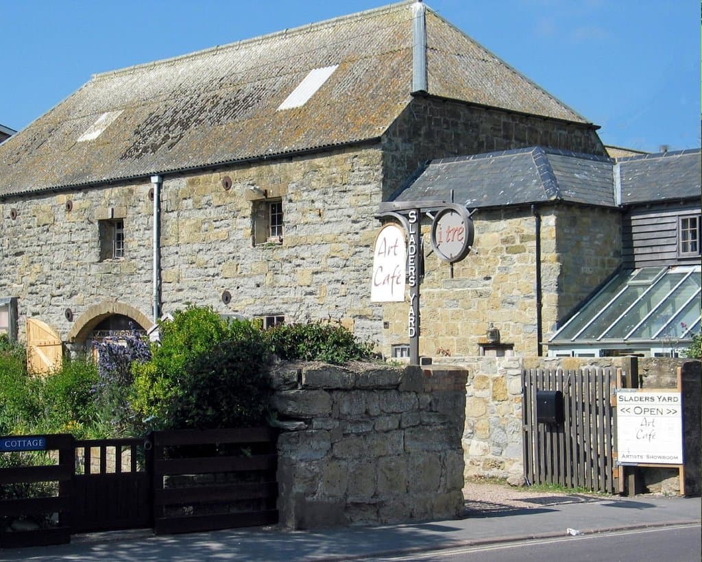 Sladers Yard is set back from the road by a gravel courtyard.