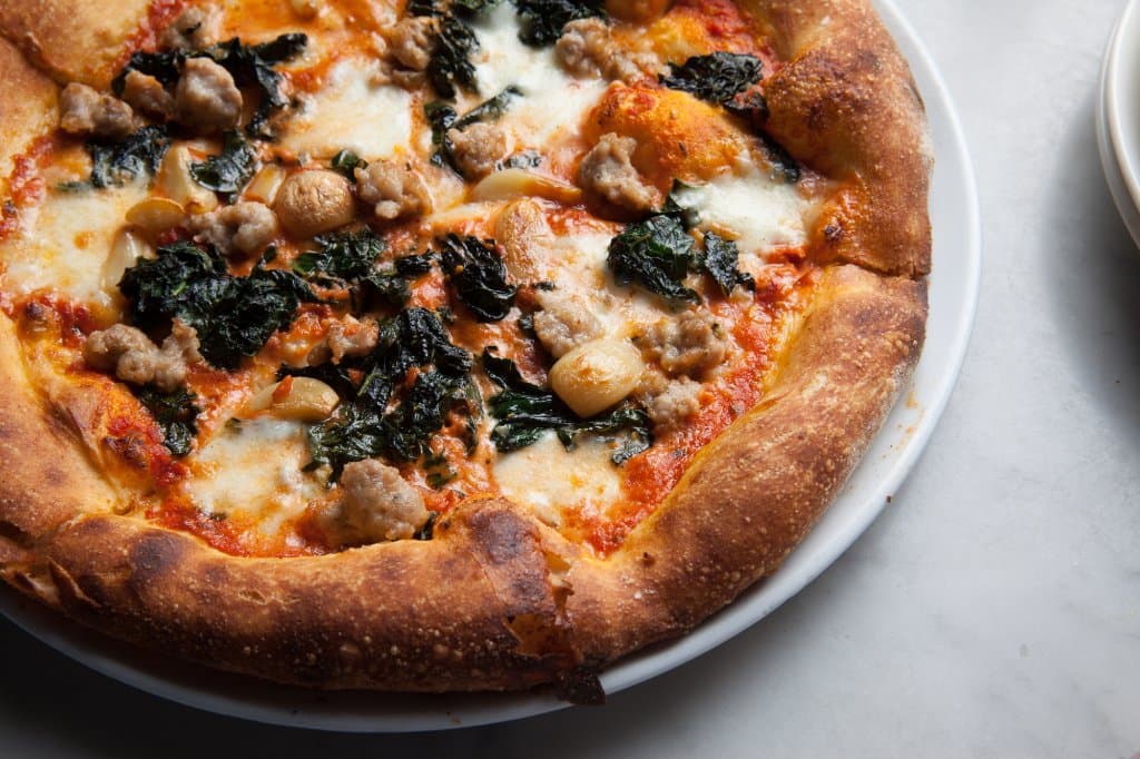 This pizza with housemade pork belly sausage and kale is a winner year-round.