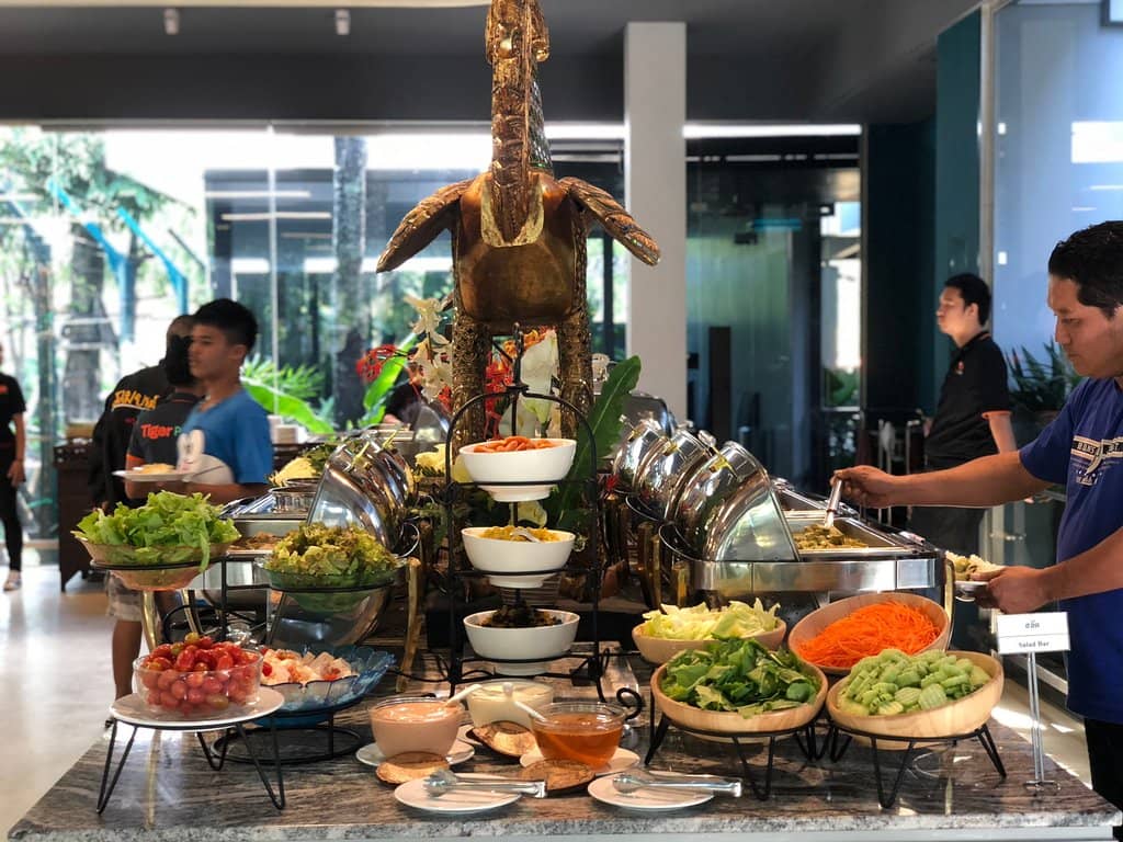 Tiger Feeding from a Caged Bus
