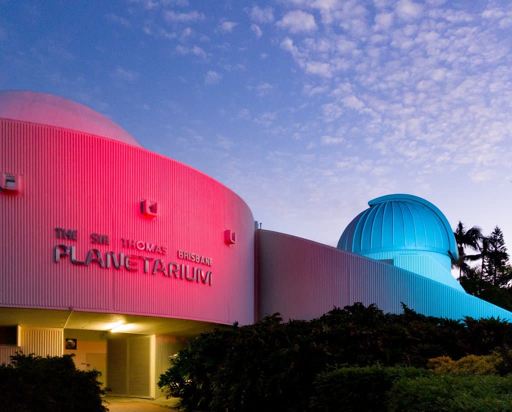 The Cosmic Skydome exterior on the left, and the observatory dome on the right, around sunset.
