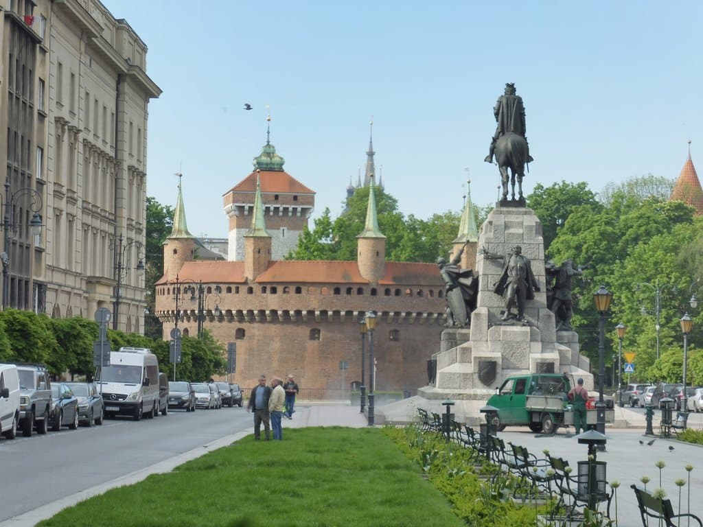 In the background, Saint Florian’s Gate , then the Kraków Barbican (Barbakan Krakowski), and the Grunwald Monument