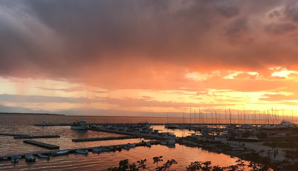 a beautiful cloudy sunset with bright colors at the marina of Thessaloniki after a hot spring day with over 30C degrees