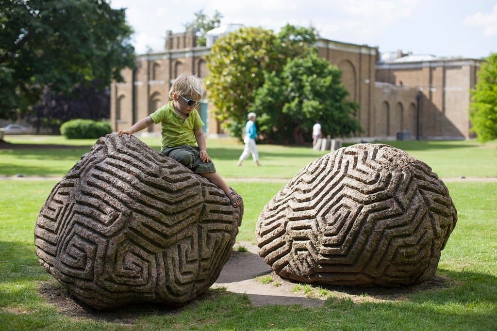 A visit to Dulwich Picture Gallery's gardens provides a great opportunity to explore art and architecture in one setting. See Peter Randall Page’s outdoor sculpture Walking the Dog (pictured in the foreground above). Carved out of granite, the design echoes the frieze on the Gallery exterior. Why not also take a moment to appreciate the intricate patterns, lines and shadows of our iconic building, designed by late-Georgian architect Sir John Soane?
