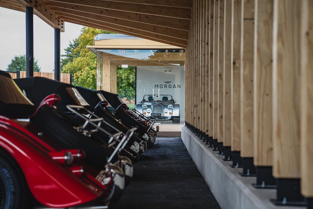 A selection of used Morgan cars underneath the wooden canopy at the front of the building