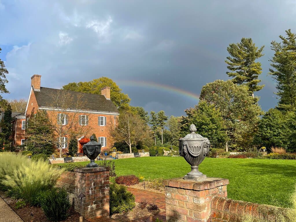 A rainbow appears over Mt. Cuba Center's Copeland House following an early fall shower.