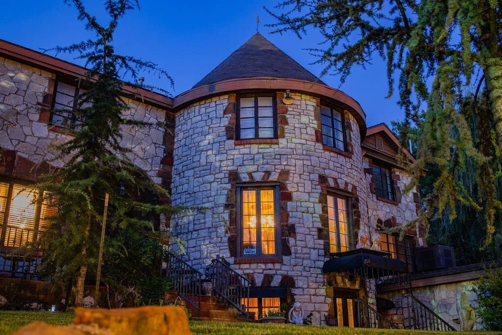 Castle Falls, the stunning dream home built by WWI veteran Bill Blecha, is beautifully illuminated in this night shot. Its stone facade, a detailed replica of a Normandy castle, truly makes it a unique setting for the Castle Falls Restaurant. Ready to experience it for yourself? We're open for dinner on Thursday, Friday, and Saturday.