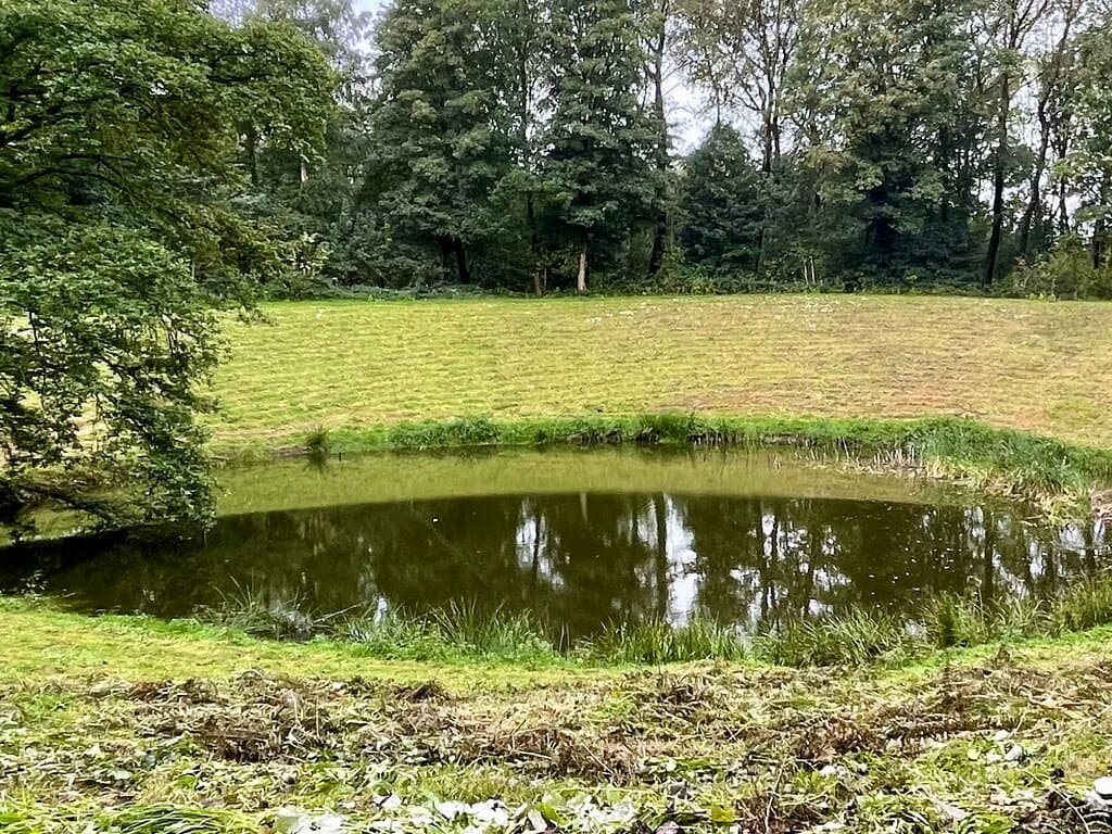 Caterpillar Crater looks like a peaceful lake today but it was the result of one of many WWI underground mine explosions that left massive craters across the landscape of the Western Front.